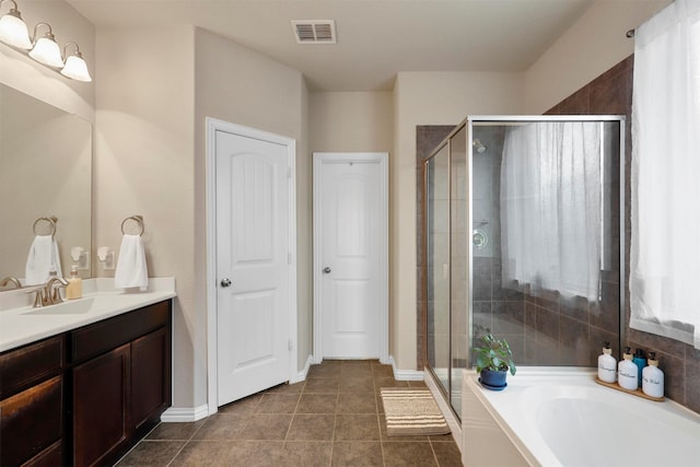 bathroom with shower with separate bathtub, tile patterned floors, and vanity