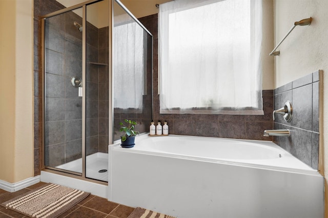 bathroom featuring tile patterned floors and independent shower and bath