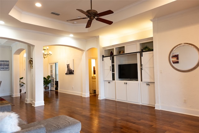 living room featuring ceiling fan, crown molding, a tray ceiling, and dark wood-type flooring