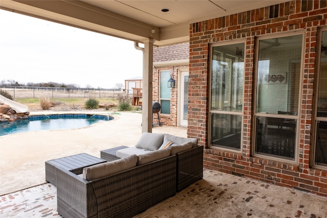 view of patio with outdoor lounge area and a fenced in pool