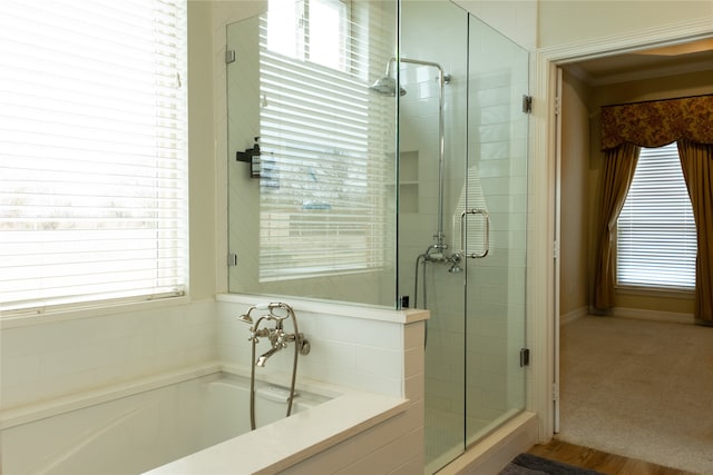 bathroom featuring shower with separate bathtub