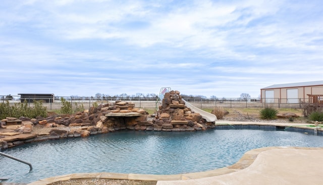 view of pool featuring a water slide