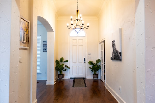 entryway featuring a notable chandelier, dark hardwood / wood-style flooring, and ornamental molding