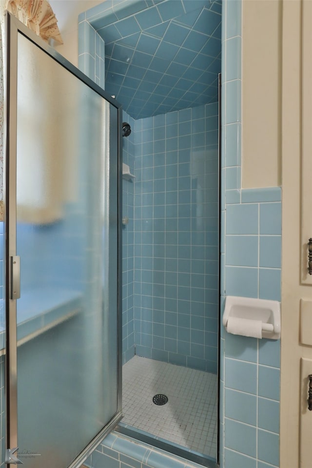 bathroom featuring tile walls and walk in shower