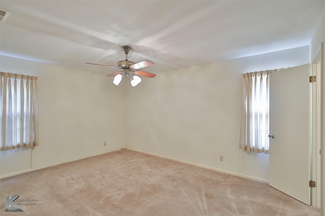 carpeted empty room featuring ceiling fan