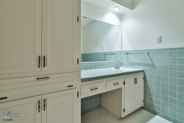 bathroom with tile walls, tile patterned floors, vanity, and decorative backsplash