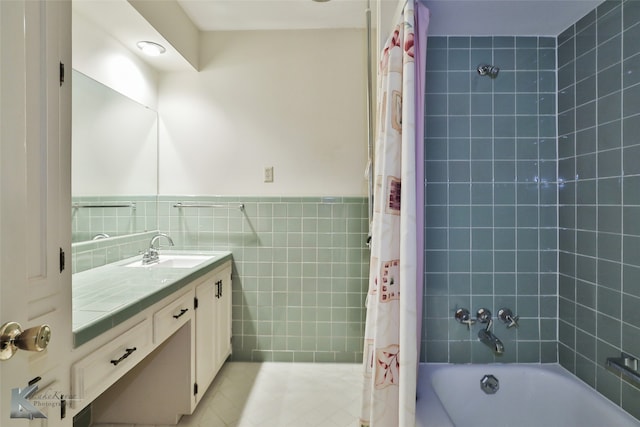 bathroom featuring tile walls, shower / bathtub combination with curtain, tile patterned floors, and vanity