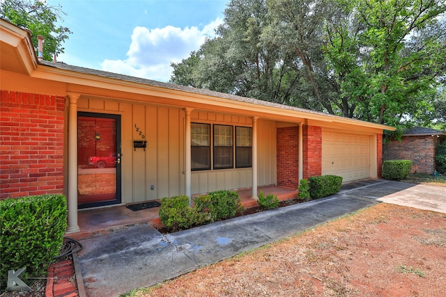 view of front of home featuring covered porch and a garage