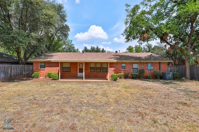 view of front of house with a front yard and cooling unit