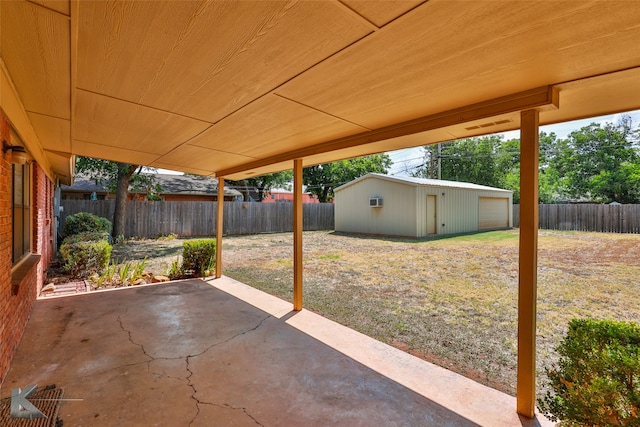 view of patio / terrace with a garage and an outdoor structure