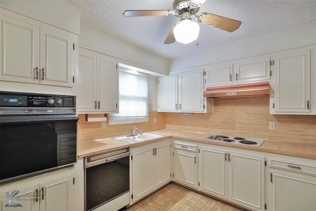 kitchen featuring a textured ceiling, ceiling fan, black appliances, light tile patterned flooring, and sink