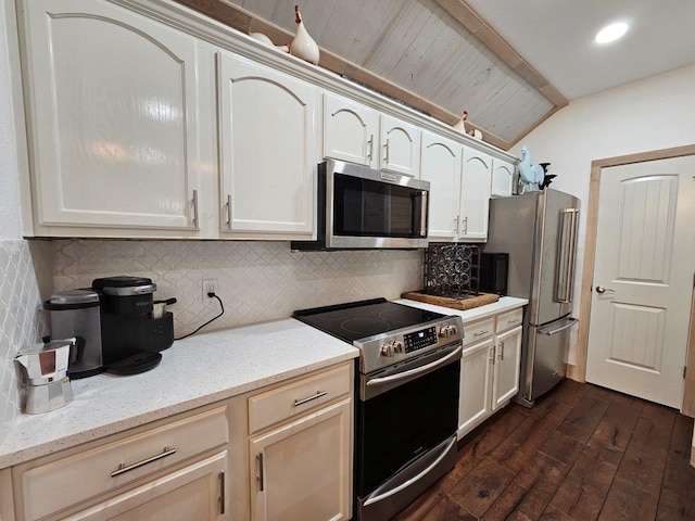 kitchen featuring backsplash, lofted ceiling, stainless steel appliances, and dark wood-type flooring