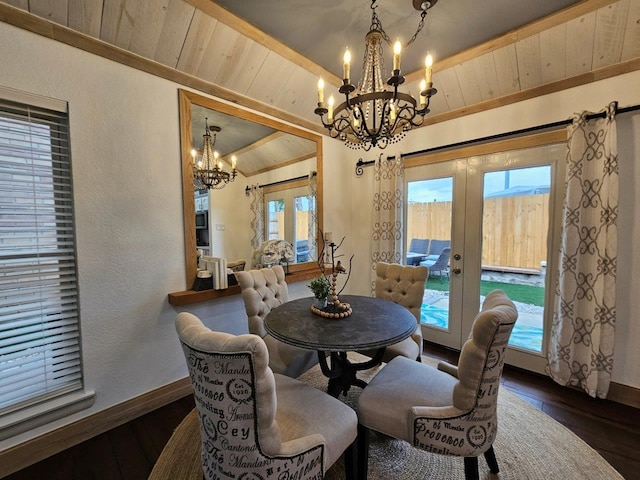 dining area featuring plenty of natural light, dark hardwood / wood-style flooring, vaulted ceiling, and a chandelier