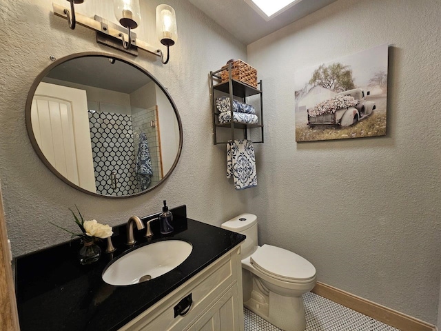 bathroom with tile patterned floors, vanity, and toilet