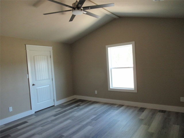 empty room featuring lofted ceiling, hardwood / wood-style flooring, and ceiling fan