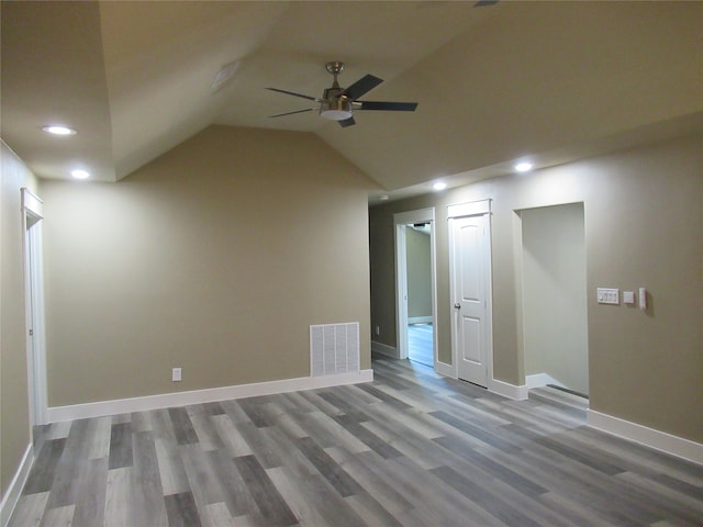 interior space with ceiling fan, lofted ceiling, and wood-type flooring