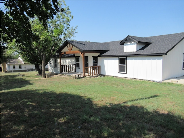 rear view of house featuring a yard