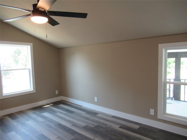 empty room featuring ceiling fan, wood-type flooring, lofted ceiling, and a healthy amount of sunlight