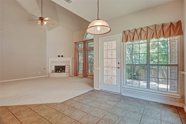 unfurnished living room featuring baseboards, high vaulted ceiling, a fireplace, ceiling fan, and light colored carpet