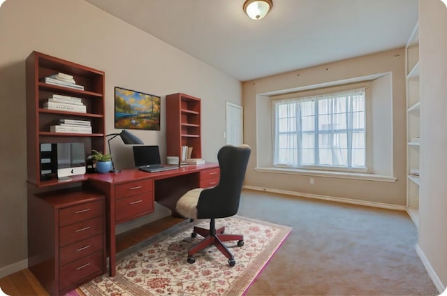 carpeted office with baseboards