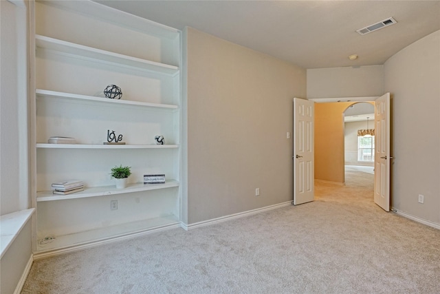 unfurnished bedroom with visible vents, baseboards, and carpet