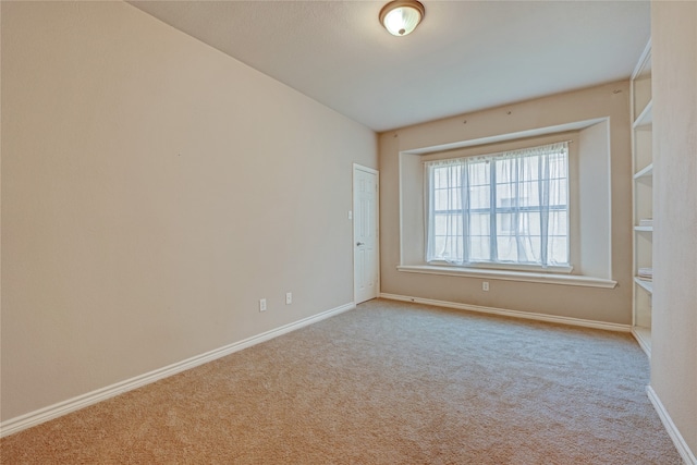 empty room featuring light carpet