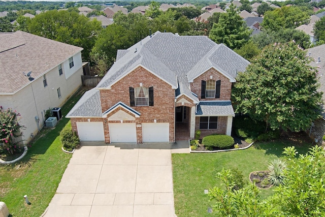 view of front property featuring a front lawn and a garage