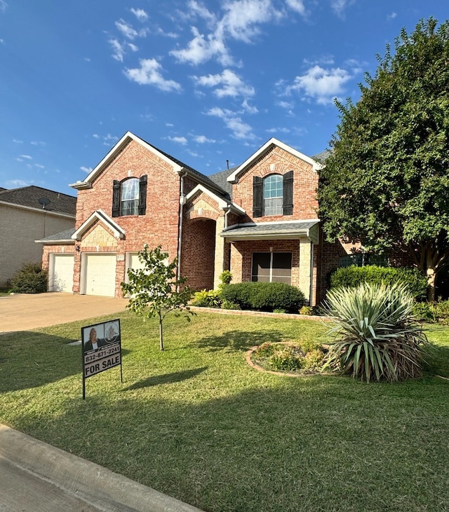 view of front of house with a front lawn and a garage