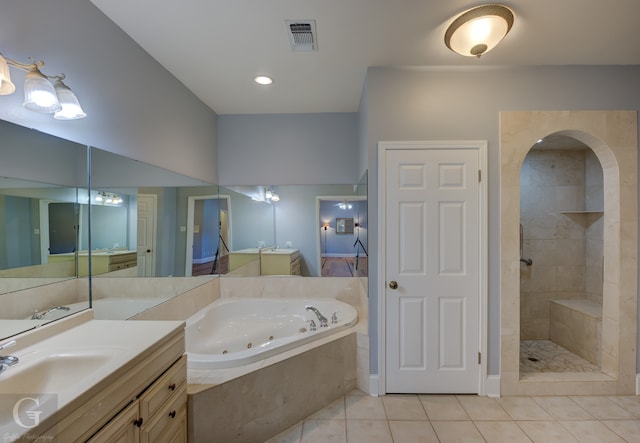 bathroom with plus walk in shower, vanity, and tile patterned flooring