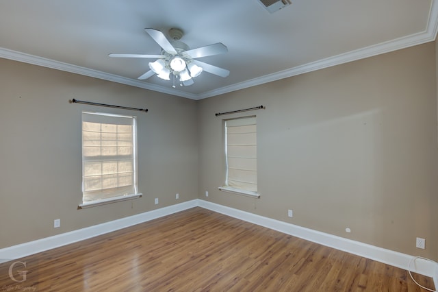 empty room featuring ceiling fan, crown molding, and wood-type flooring