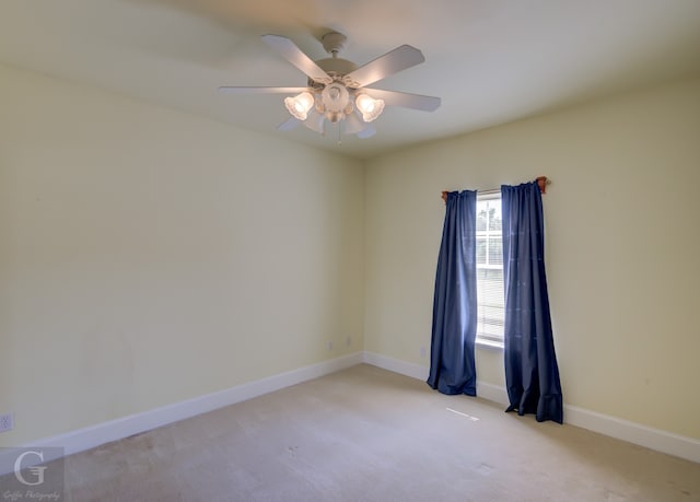 spare room featuring ceiling fan and light colored carpet