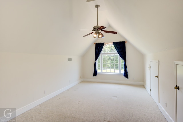 additional living space featuring ceiling fan, light colored carpet, and vaulted ceiling