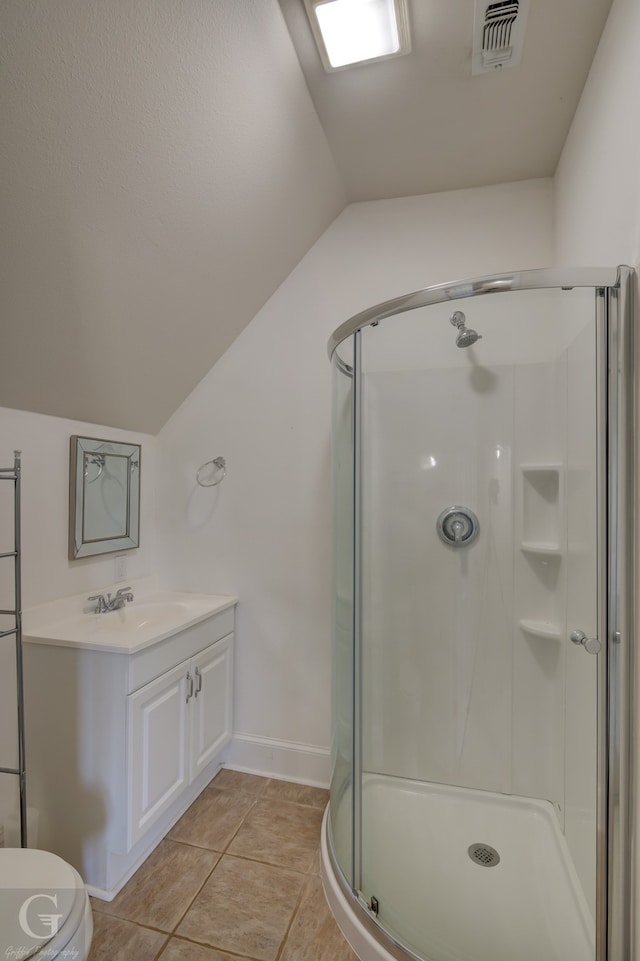 bathroom with lofted ceiling, toilet, tile patterned floors, vanity, and a shower with shower door