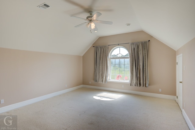 additional living space with ceiling fan, vaulted ceiling, and light carpet