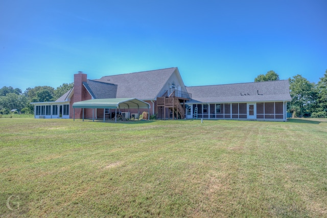 back of property with a wooden deck and a yard