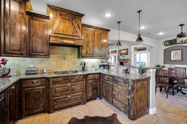 kitchen featuring ceiling fan, light tile patterned flooring, and stone countertops