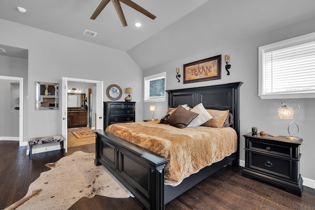 bedroom featuring multiple windows, dark hardwood / wood-style flooring, ceiling fan, and ensuite bathroom