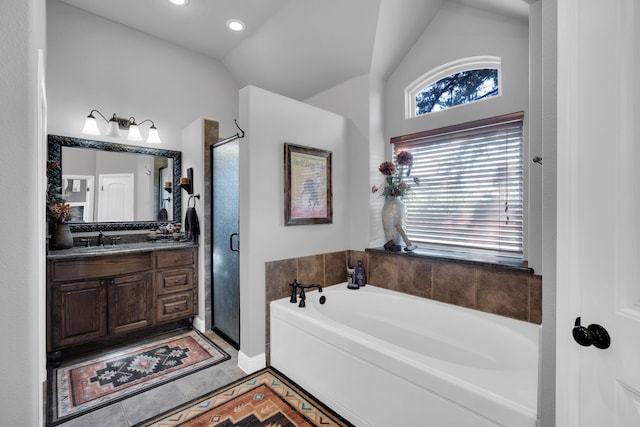 bathroom featuring vanity, plus walk in shower, tile patterned flooring, and vaulted ceiling