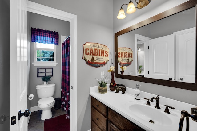 bathroom featuring toilet, tile patterned floors, and vanity