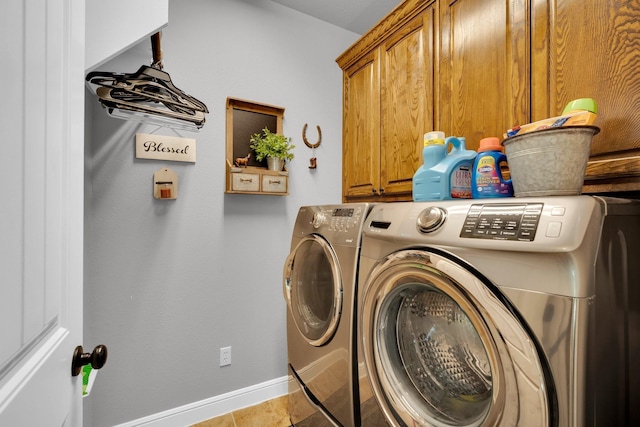 laundry area featuring cabinets, washing machine and dryer, and light tile patterned flooring