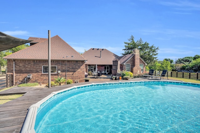 view of swimming pool featuring a deck