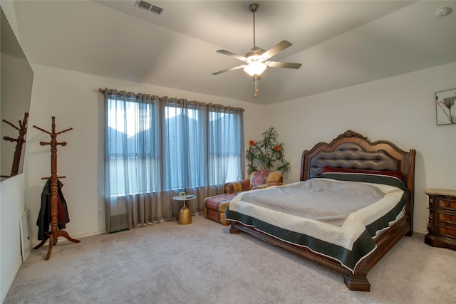 bedroom featuring ceiling fan, vaulted ceiling, and light colored carpet