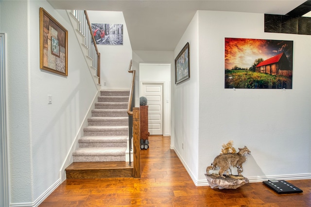 hallway with hardwood / wood-style floors