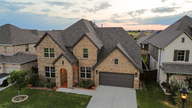 view of front of house with a lawn and a garage