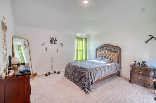 carpeted bedroom with vaulted ceiling