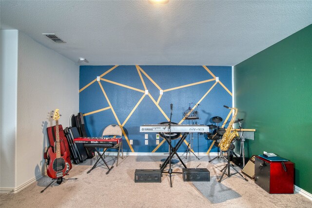 game room featuring a textured ceiling and carpet floors