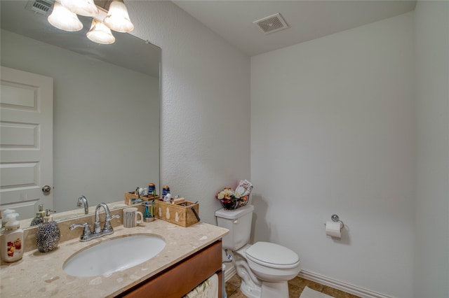 bathroom featuring tile patterned floors, vanity, and toilet