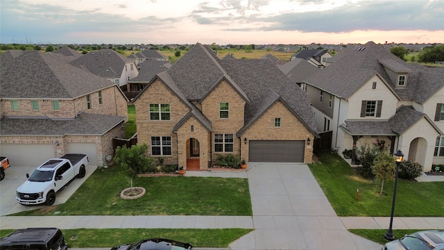 view of front of property with a garage and a lawn