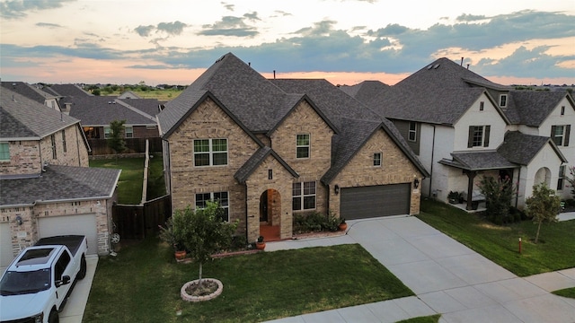 view of front facade with a garage and a yard