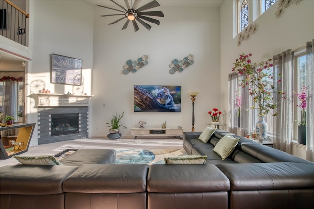 living room with a high ceiling and a healthy amount of sunlight